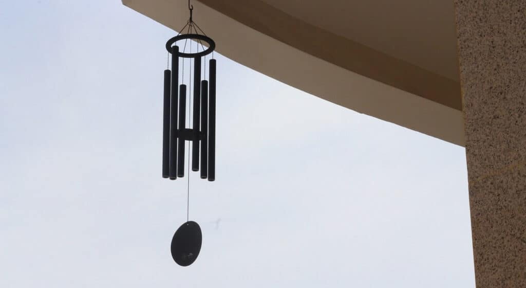 Photo of a Wind Chime hanging from a timber beam